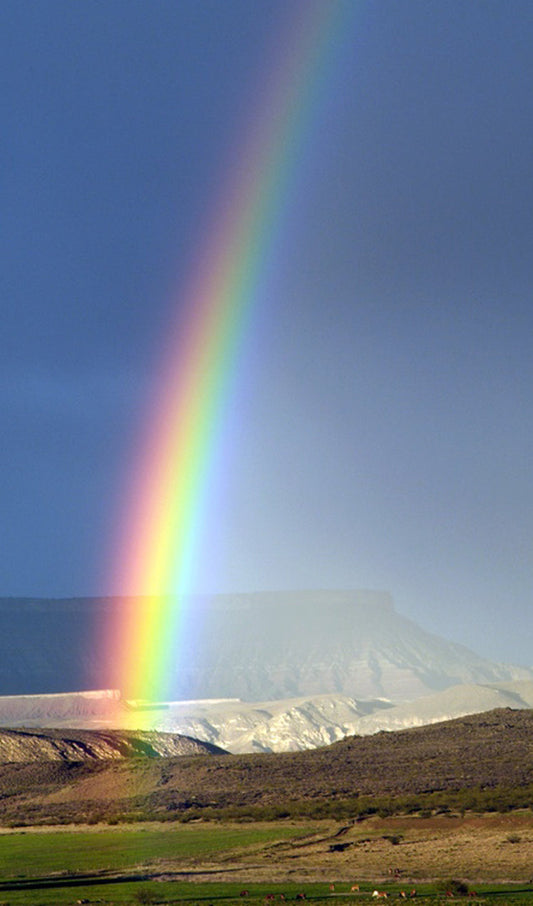 Rainbow in Front of Cliffs